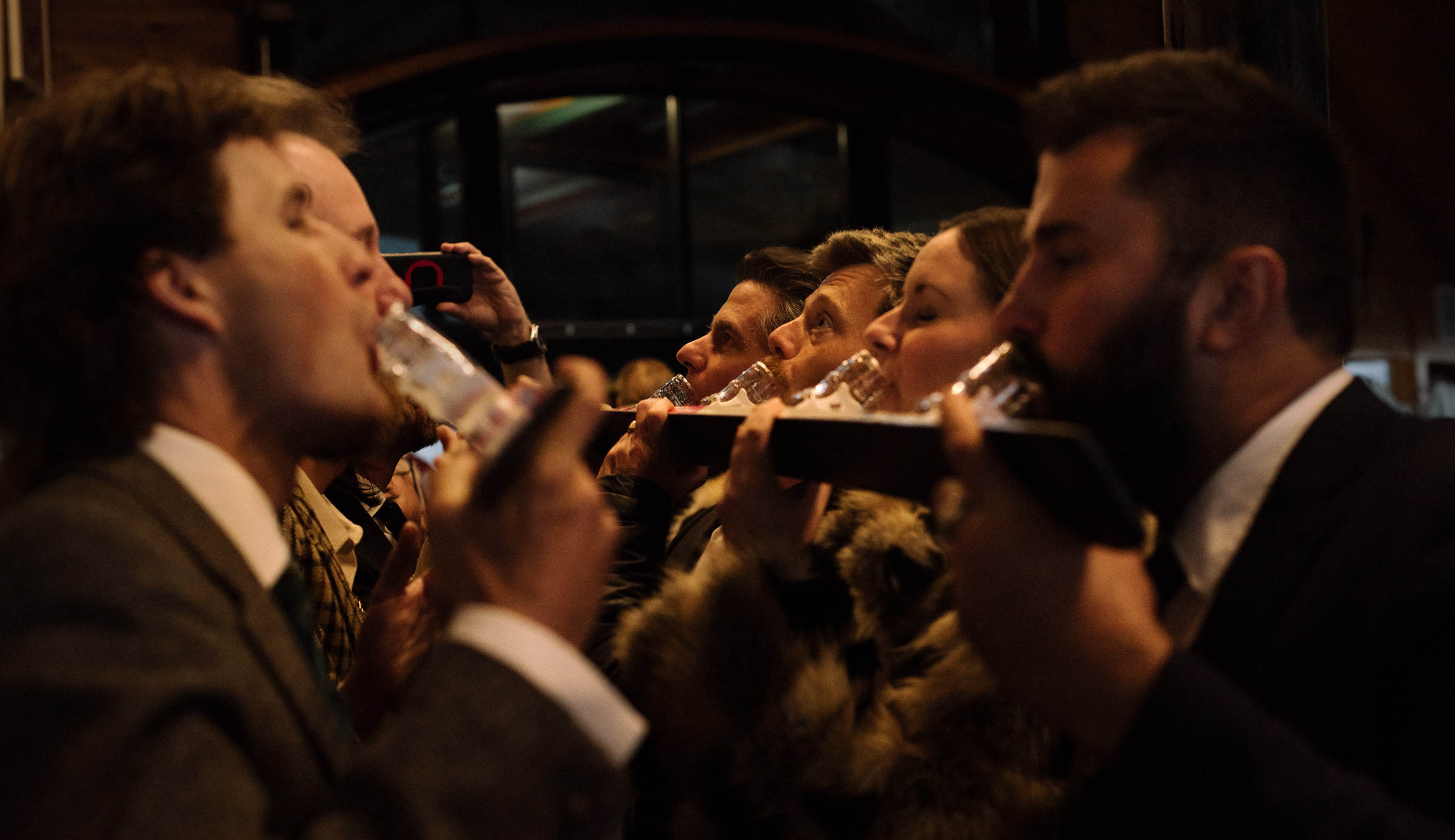 guests have a shotski at the wedding reception