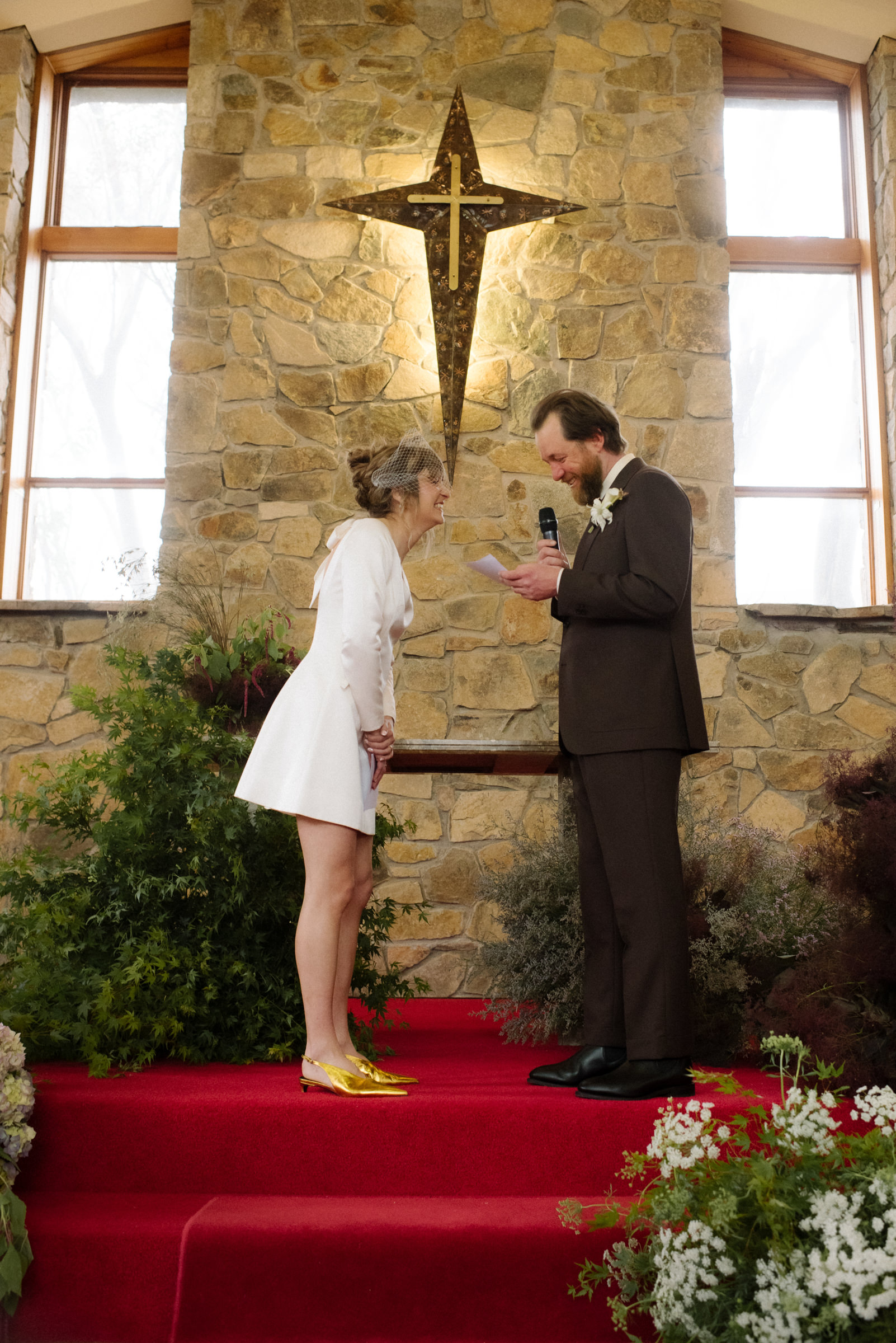 the couple have a laugh during the groom's vows