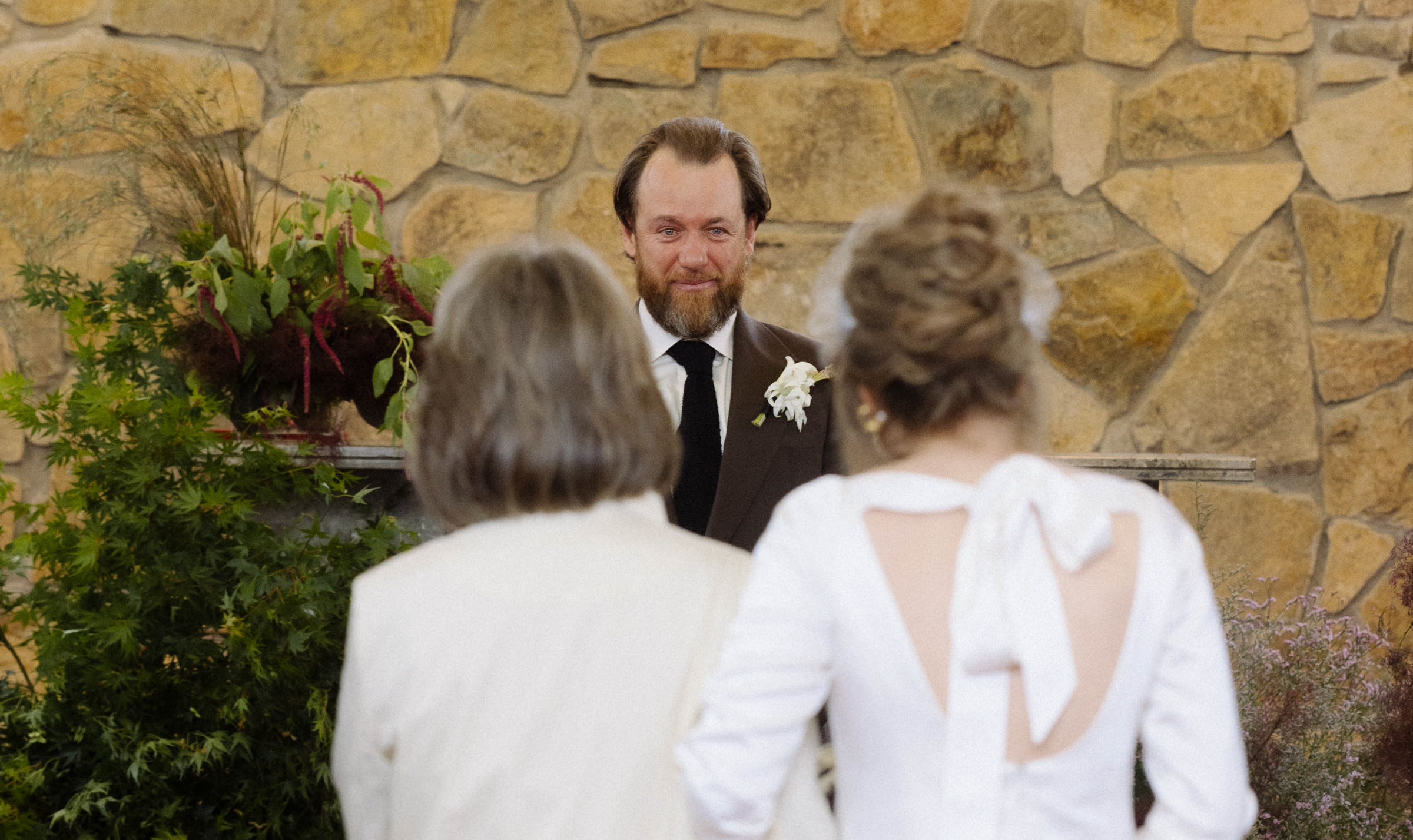 the groom sees the bride as she gets to the top of the aisle at the chapel