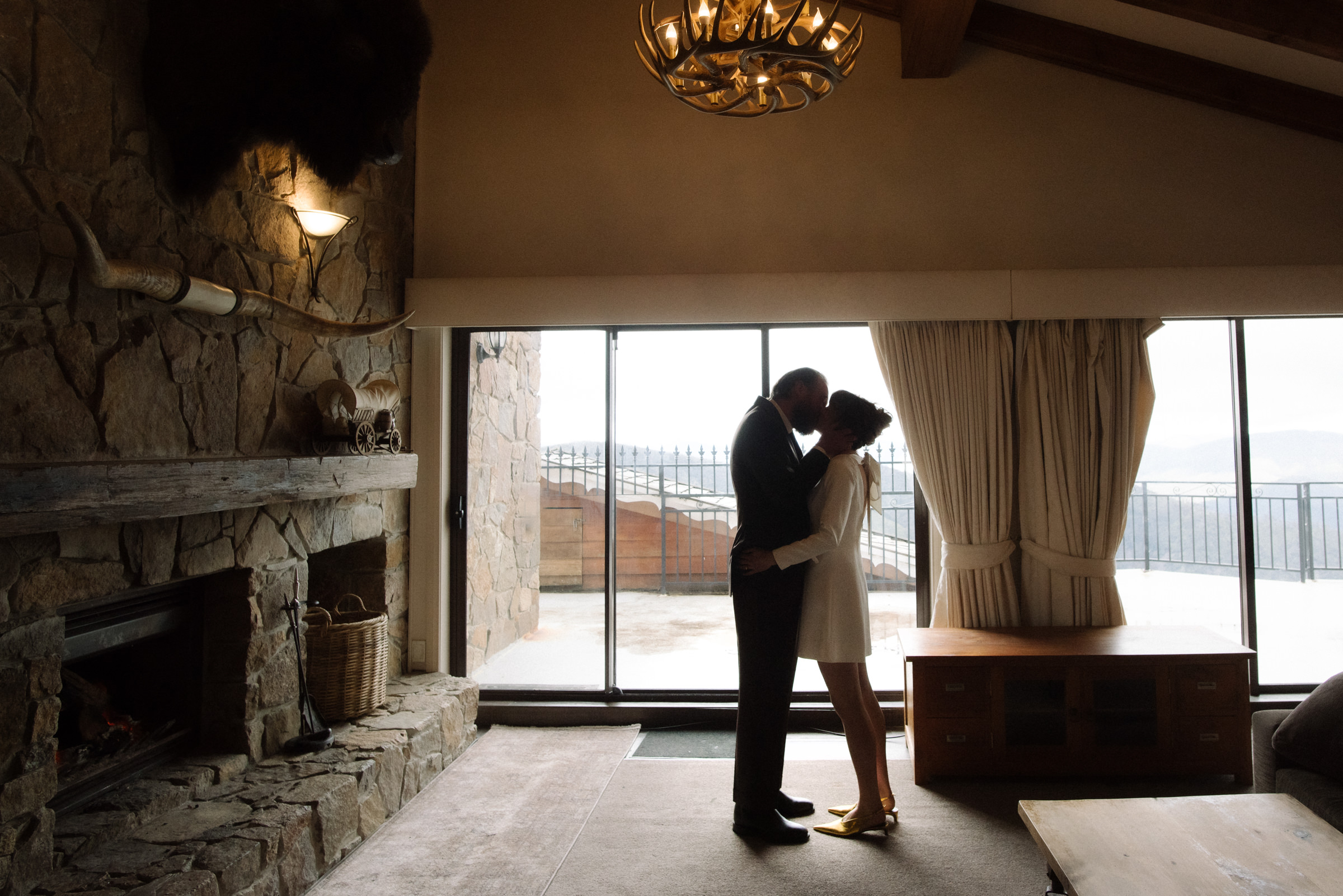 a couple share a kiss before they head off to get married at the chapel on Mount Buller