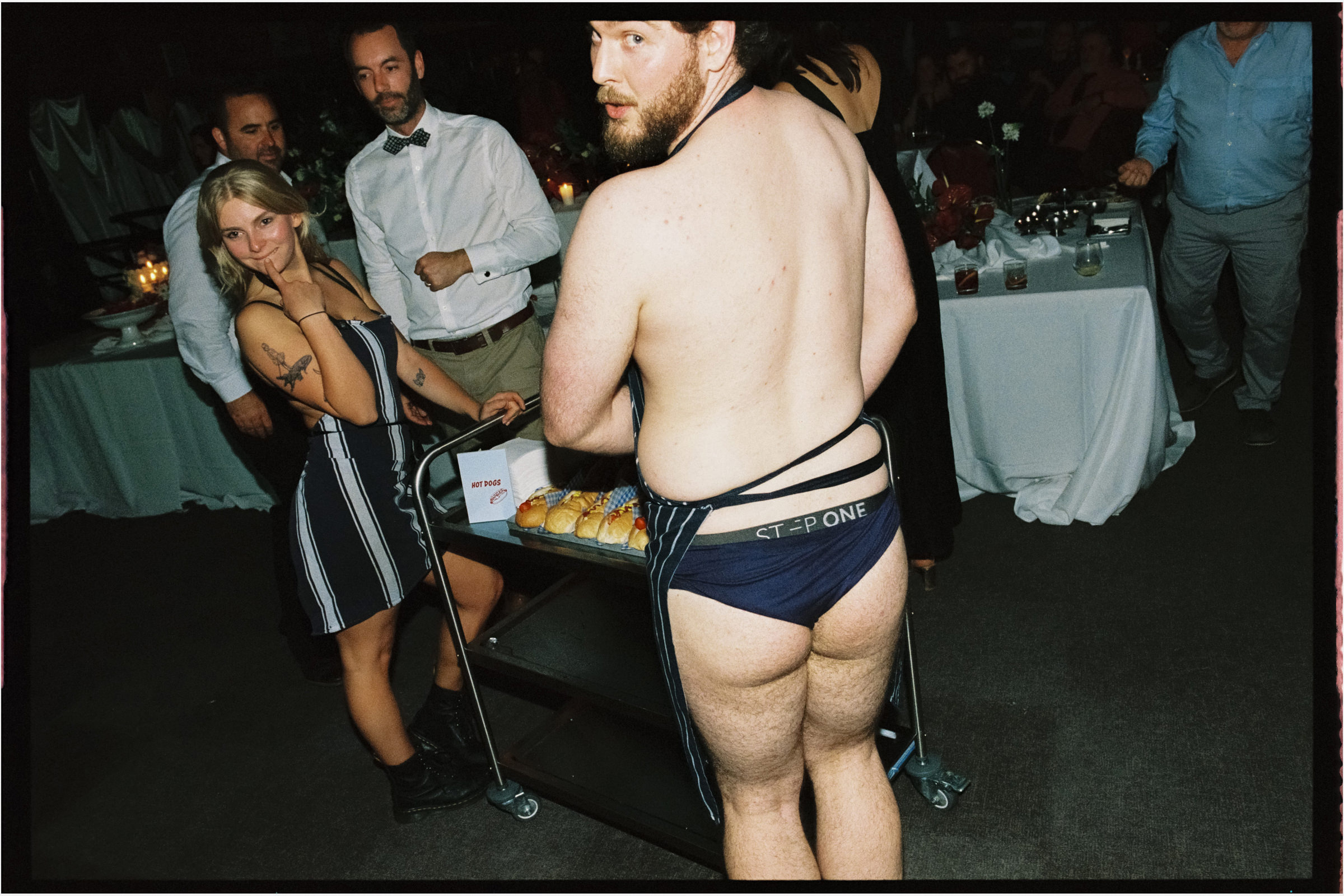 a scantily clad hot dog vendor at the wedding reception