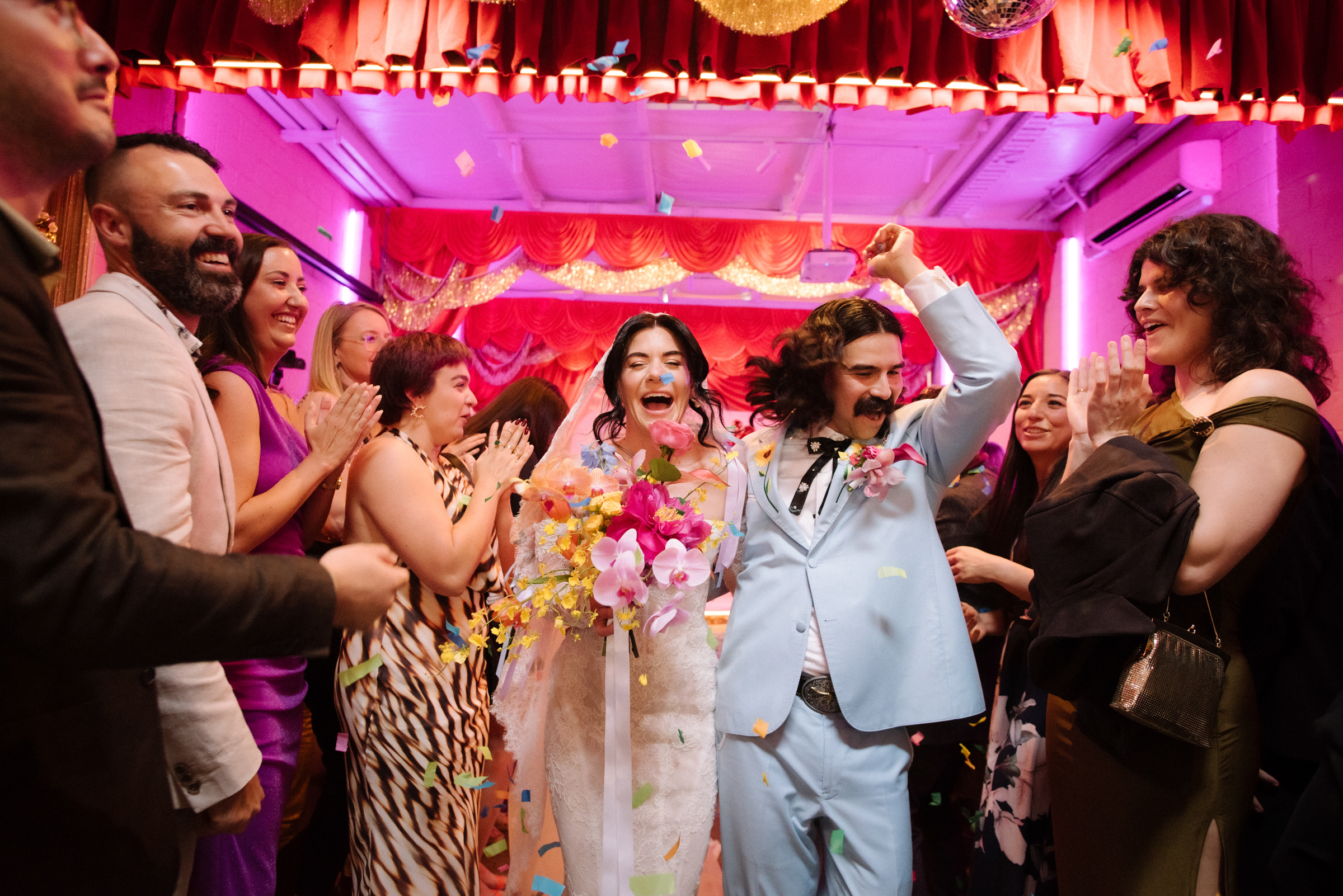 the bride and groom head back down the aisle after getting married