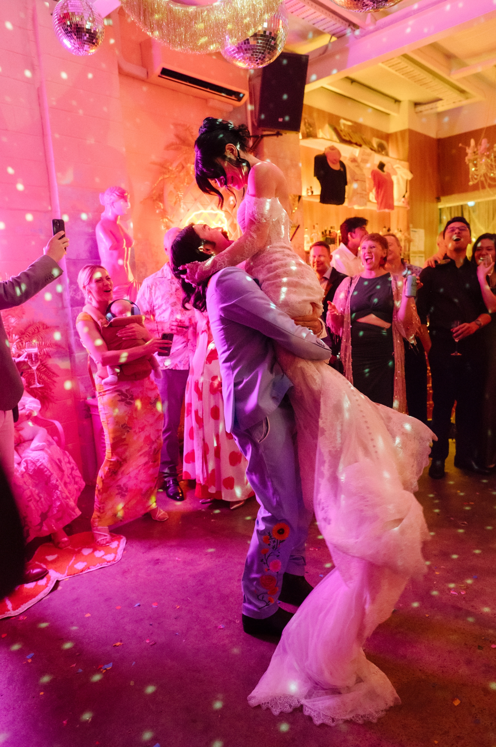 the groom lifts the bride during their first dance