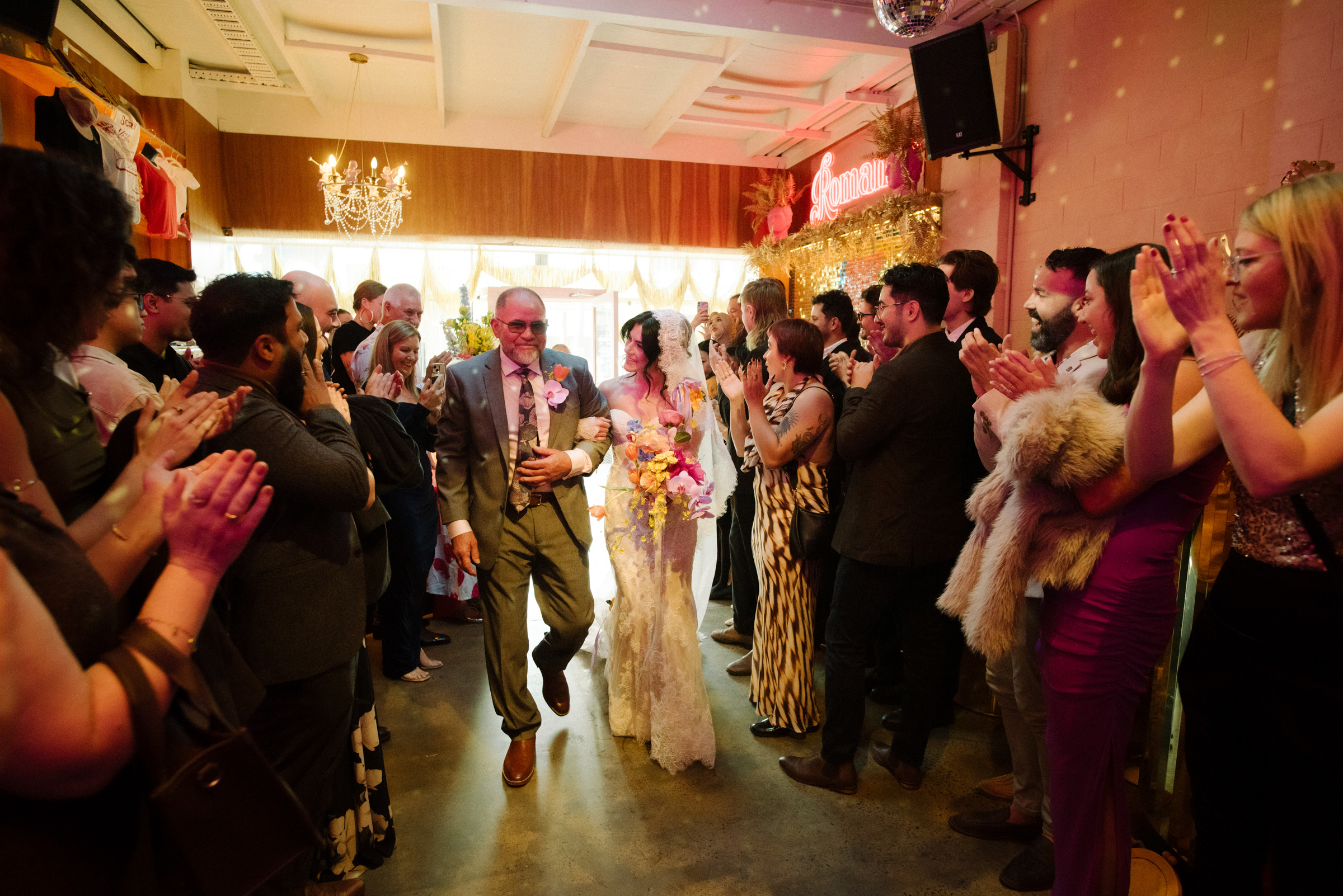 the bride and her father come down the aisle at the start of the wedding ceremony