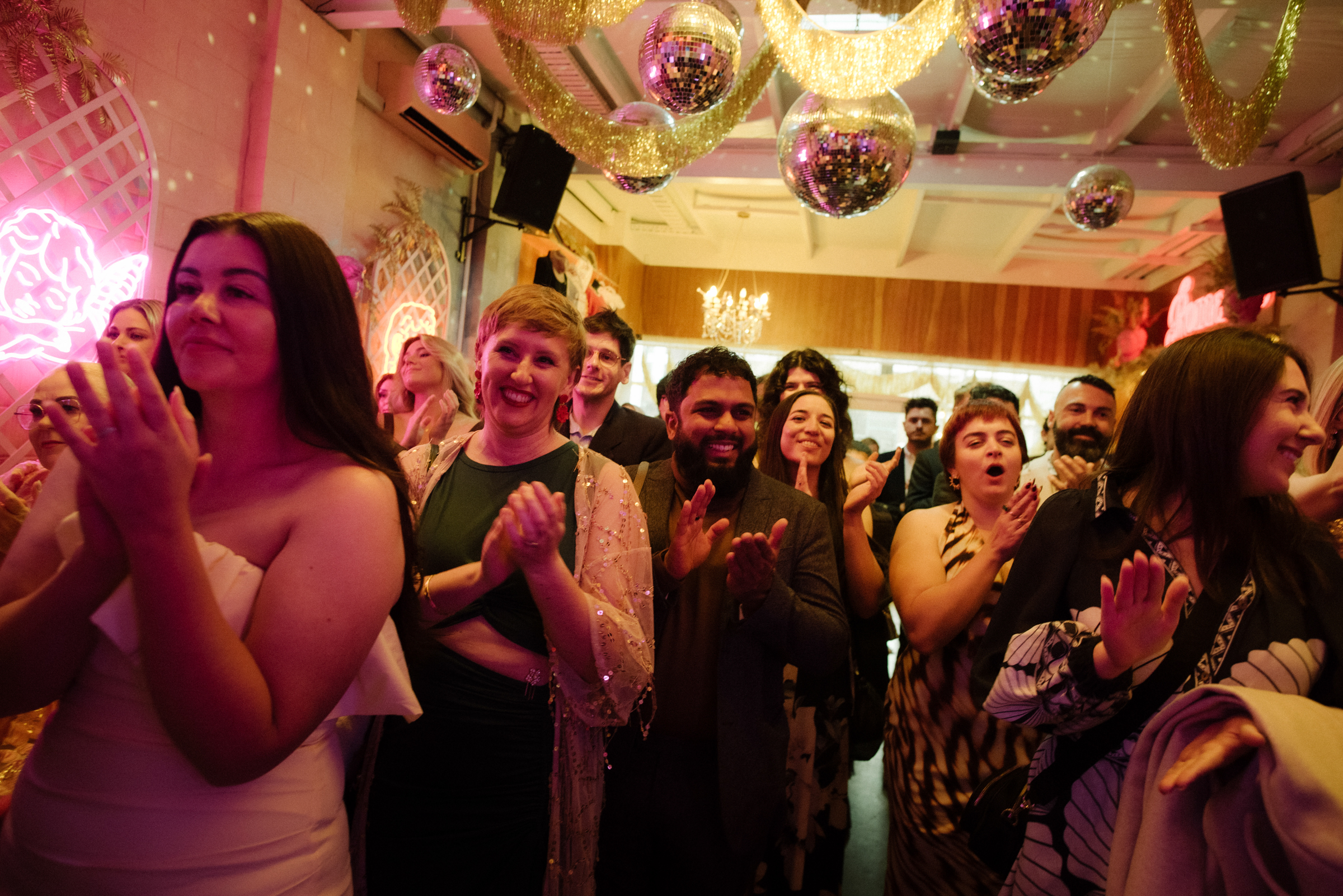 weddings guest clap and cheer as the couple is pronounced as married