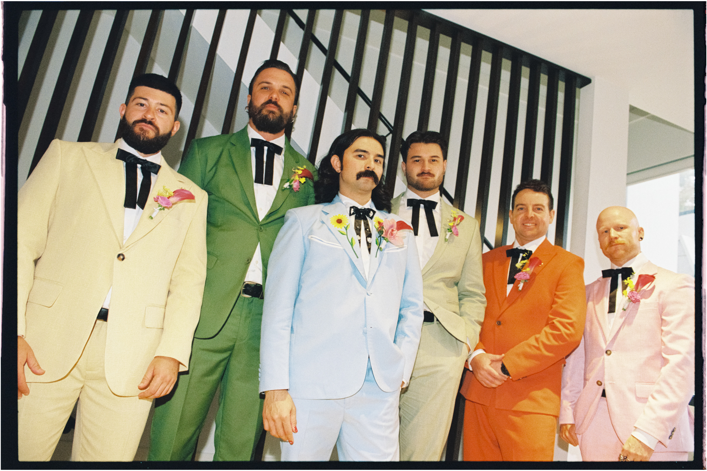 a film photo of the groomsmen in their colorful suits
