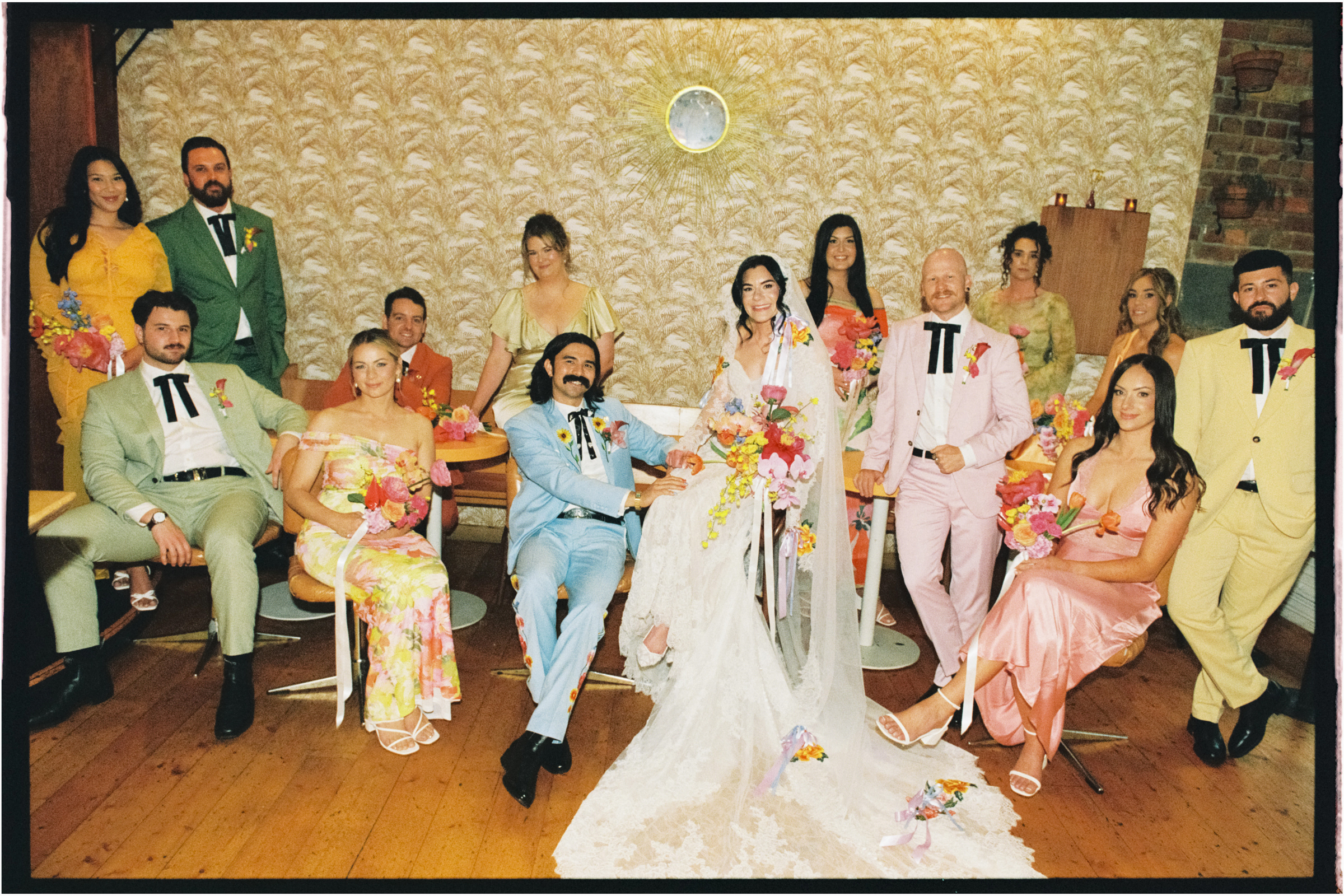 A bridal party pose for a group portrait at a bar in Abbotsford